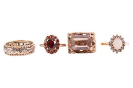 Four gem-set rings in 9ct gold; to include a Modernist ring set with a smokey quartz with canted cor