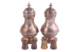 A pair of George II silver pepperettes, of baluster form, with band to belly, pierced pull-off cover