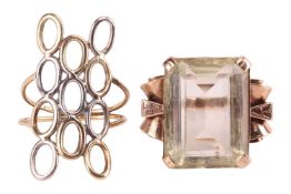 A cocktail ring set with an octagonal-cut prasiolite of 19.5 x 14.8 x 8.3 mm, between voluted should