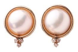 A pair of Mabé pearl and diamond stud earrings, each contains a round Mabé pearl within a conforming