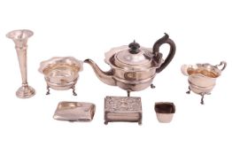 A group lot of silver items, comprising a silver three piece tea set, the teapot with ebonised knop 