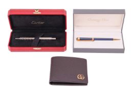 A cased Christian Dior ballpoint pen with navy blue barrel and engraved with name; a cased Cartier b
