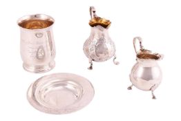 A silver baluster mug with engraved inscription, London 1924, a silver ashtray with chased flower de