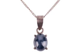 A star sapphire pendant on chain, claw-set with an oval star sapphire cabochon of dark blue colour, 