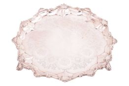 A Victorian salver, circular, the pie crust border decorated with shells and scrolls; on three scrol