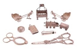 A pair of silver storks pulling baby chariots, import marks, a silver whistle, a pair of silver egg 