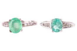 Two emerald and diamond rings; one navette-shaped with a central oval cut emerald in claw mount and 