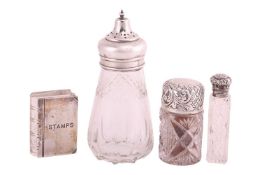 A glass stamp box in book form with silver hinged cover inscribed 