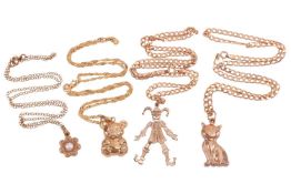 A collection of jewellery items including a 9ct gold cat pendant, a 9ct gold pearl-set floral pendan