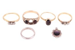 A collection of five rings and a pendant; to include a garnet three-stone ring in 9ct gold, principa