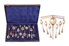 A cased set of twelve gilt and enamel decorated spoons, nine with named views to the bowls, two with