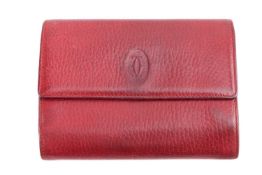 Cartier - a tri-fold wallet in burgundy leather, with card compartments and a kiss lock pouch for co