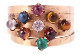 A Thai nine gem 'Noppakao' Harem ring, comprising five rings adjoined at the base, claw-set with rou