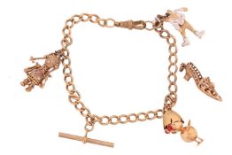 A 9ct gold charm bracelet, featuring four charms including a gem-set doll and clown charm, both of a
