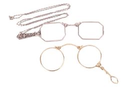 Two Edwardian lorgnettes; the first pair with circular lenses and spring mechanism, engine-turned pa
