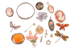 A group lot of jewellery to consist of four small charms, a large butterscotch amber brooch in flora