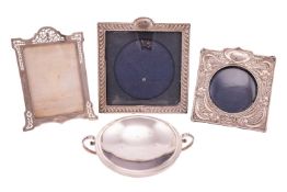 Three silver photograph frames and a silver bowl, of round form with two beaded scroll handles and l