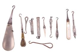 A large collection of 19th century and later buttonhooks, some with silver handles, others with whit