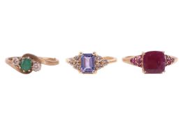Three gem-set rings; including a tanzanite dress ring in 14ct yellow gold with diamond cluster shoul