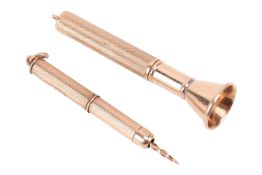 A 9ct gold cigar piercer, of tapered form with grooved barrel, the removable cover of engine-turned 