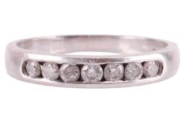 A diamond half-hoop ring in platinum, comprising seven graduated brilliant-cut diamonds with an esti