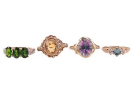 Four gem-set rings in 9ct gold; including a chrome diopside three-stone ring with diamond shoulders 