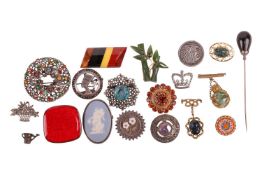 A collection of brooches; includes examples of a multi-coloured layered bakelite brooch, a Danish gl