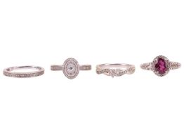 A collection of four dress rings in 9ct white gold; to include a rhodolite garnet and diamond halo r