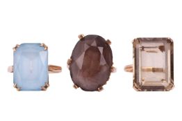 Three large gem-set rings; to include a scissors-cut pale blue paste ring in 9ct gold, size R; an oc