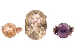 Three gem-set rings; to include a large citrine dress ring in a pierced scrollwork gallery, oval-cut