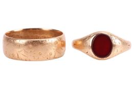 Two 18ct gold rings; An 18ct gold ring, with floral engraving, Chester, 1891, size Q ; A red paste s