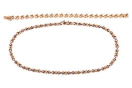 A 9ct gold bi-tone necklace and a yellow metal bracelet; The necklace with oval and stylised cross-l