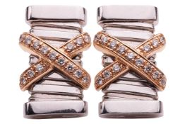 A pair of diamond set earrings of lashing cross design against a rectangular white metal base, estim