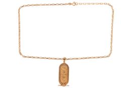 An Egyptian cartouche pendant on a cable link chain, the pendant decorated with a scarab beetle moti