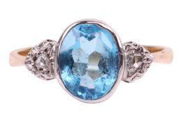 A blue topaz and diamond ring, bezel-set with a mixed oval-cut topaz, of vivid blue colour, measurin