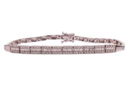 A diamond-set link bracelet, comprising a series of articulated bar links, with the central segment 
