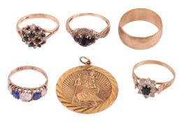 Four gem set rings, a 9ct gold band and a 9ct gold St Christopher pendant; The first a gem set clust