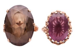 A smokey quartz ring and a purple paste ring; the first ring comprising a large oval-cut smokey quar