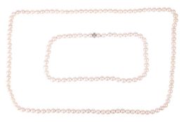 Two cultured pearl necklaces, the first featuring pearls measuring approximately 8mm, with silver ov
