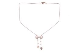 An Edwardian diamond and pearl négligée necklace, of bow design, set with single-cut diamonds and a 