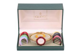 Gucci - a wristwatch and bezel set, circa 1980s, with a quartz movement and gilt case measuring 26mm