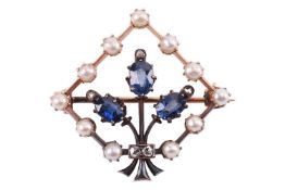 An Edwardian gem-set brooch of foliate design, centred with a spray motif, flowerhead set with oval-