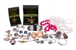 A group of jewellery items, including two shell cameo brooches, each depicting a portrait of a lady,