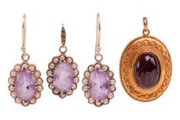 An amethyst and pearl pendant and earring suite, each piece featuring an oval amethyst surrounded by