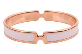Hermès – An Olympe rose metal and leather bangle, a closed bangle comprising of white calfskin leath