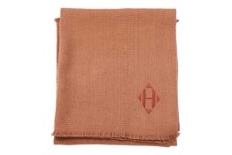 Hermès - a muffler in camel wool and cashmere, with fringe edges and an embossed leather 'H' at the 