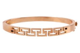 A Greek-style hinged bangle, in yellow metal with Greek key pierced design, testing as 18ct, secured
