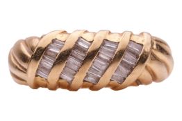 A diamond-set dress ring of twisted rope design, embellished with four diagonal rows of channel-set 