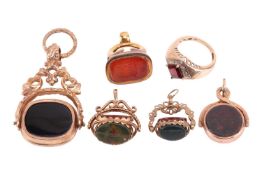 A collection of four swivel fobs, set with carnelian, onyx and bloodstone and decorated with scrollw