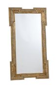 A GILTWOOD AND COMPOSITION WALL MIRROR